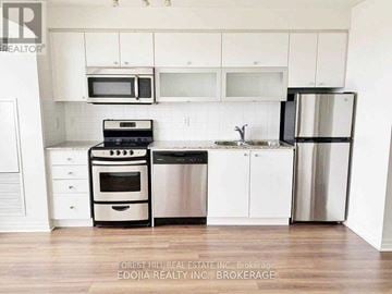 Toronto (Henry Farm) condo for rent - A kitchen with white cabinets and stainless steel appliances.