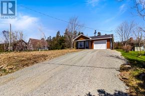 St. John's apartment for rent - A gravel driveway leads to a two-story house with a garage.