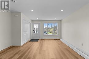 St. John's apartment for rent - A spacious room with wooden floors and white walls.