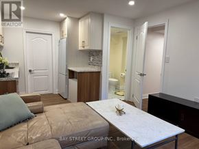 Vaughan (Vellore Village) apartment for rent - A kitchen with a table and chairs in the middle of the room.