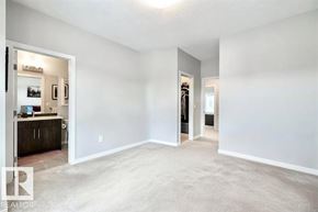 Edmonton townhouse for rent - A spacious living room with a carpeted floor and a doorway leading to another room.