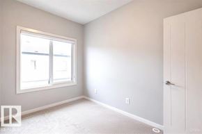 Edmonton townhouse for rent - A white room with a door and a window.