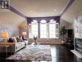 Mississauga (Central Erin Mills) apartment for rent - A living room with a couch, a coffee table, and a fireplace.