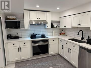 Toronto (Willowridge-Martingrove-Richview) apartment for rent - A kitchen with white cabinets and appliances.