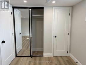 Toronto (Willowridge-Martingrove-Richview) apartment for rent - A white door with a glass panel is in a room with a wooden floor.