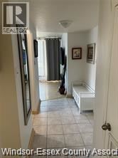 Windsor condo for rent - A hallway with a bench and pictures on the wall.