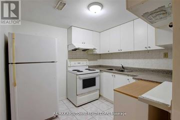 Toronto (Don Valley Village) apartment for rent - A white refrigerator is in a kitchen with white cabinets.