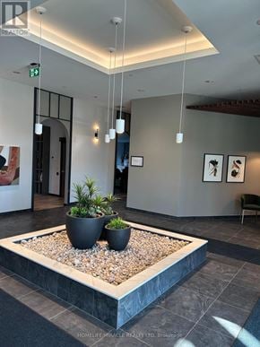 Kitchener condo for rent - A reception area with a planter in the middle.