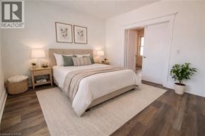Hamilton apartment for rent - A bedroom with a large bed and a plant.
