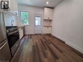 Hamilton apartment for rent - A kitchen with wood flooring and white walls.