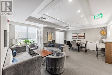 Brampton (Sandringham-Wellington) condo for rent - A living room with grey couches and a wooden table.