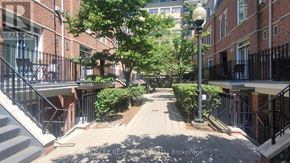 Toronto (Cabbagetown-South St. James Town) townhouse for rent - A residential street with brick buildings on either side.