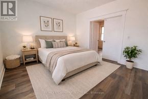 Hamilton (Stipley) apartment for rent - A bedroom with a large bed and a plant in a pot.