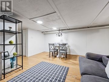 Toronto (The Beaches) apartment for rent - A living room with a grey couch and a dining table.