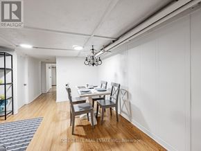 Toronto (The Beaches) apartment for rent - A dining room with a table set for two and a chandelier hanging from the ceiling.