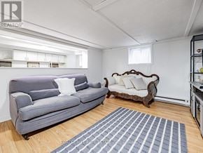 Toronto (The Beaches) apartment for rent - A living room with a grey couch and a wooden bench.
