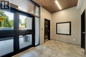 Kingsville condo for rent - A hallway with a wooden ceiling, a glass door, and a calendar on the wall.