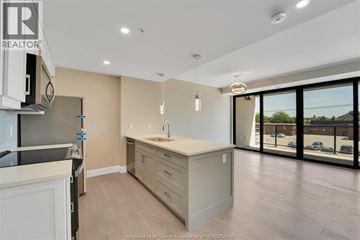 Kingsville condo for rent - A kitchen with a sink and a window overlooking a parking lot.