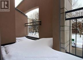 Ottawa condo for rent - A snow-covered walkway leads to a building entrance.