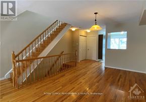Ottawa condo for rent - A wooden staircase with a light hanging from the ceiling.