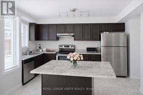 Ajax (Northeast Ajax) apartment for rent - A kitchen with a marble island and stainless steel appliances.