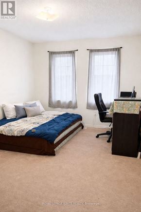 Ajax (Northeast Ajax) apartment for rent - A bedroom with a bed, desk, and chair.