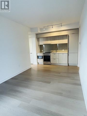 Mississauga (City Centre) condo for rent - A spacious kitchen with a stainless steel oven and white cabinets.