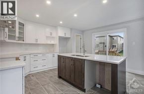 Wendover townhouse for rent - A kitchen with white cabinets and a large island.
