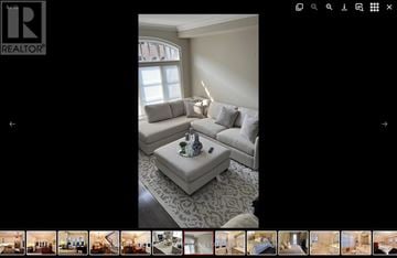 Vaughan (West Woodbridge) townhouse for rent - A living room with a grey sofa and a coffee table.