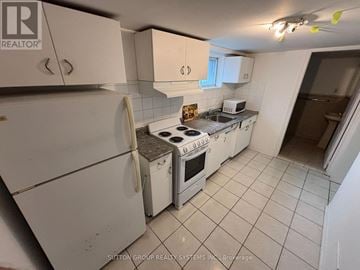 Toronto (East End-Danforth) apartment for rent - A kitchen with white appliances and cabinets.
