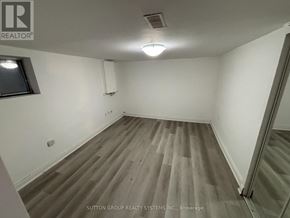 Toronto (East End-Danforth) apartment for rent - A room with wooden flooring and a window on the left side.