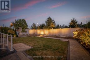 Vaughan (Vellore Village) apartment for rent - A backyard with a fence and lights on the wall.