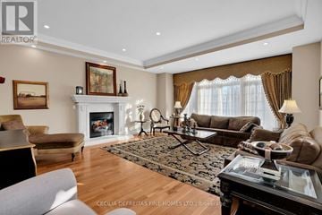 Vaughan (Vellore Village) apartment for rent - A living room with a fireplace and a painting on the wall.
