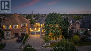 Vaughan (Vellore Village) apartment for rent - A large house with a driveway and garage is shown in the image.