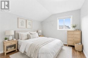 Hamilton (Strathcona) apartment for rent - A bedroom with a bed, nightstands, and a window.