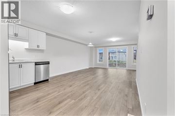 Cambridge townhouse for rent - A spacious kitchen with white cabinets and a wooden floor.