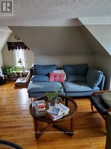 Ottawa triplex for rent - A living room with a blue couch and a wooden coffee table.