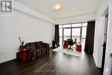 Hamilton (Waterdown) condo for rent - A living room with a striped couch and a red chair.