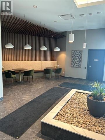 Kitchener condo for rent - A modern dining area with a long table and chairs.