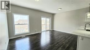 Woodstock townhouse for rent - A spacious room with wooden flooring and a large window.