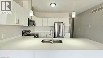 Woodstock townhouse for rent - A kitchen with white cabinets and a stainless steel refrigerator.