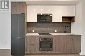 Toronto (Regent Park) condo for rent - A modern kitchen with a refrigerator, microwave, oven, and sink.