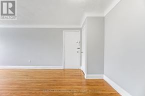 Oakville (Cp College Park) apartment for rent - A room with a white door and a wooden floor.