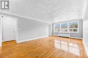 Oakville (Cp College Park) apartment for rent - A room with wooden floors and white walls, with a window showing a view of trees.