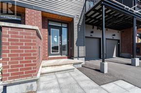 Ottawa townhouse for rent - A modern house with a brick wall and a glass door.