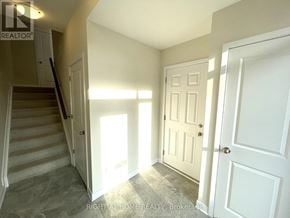Ottawa townhouse for rent - A hallway with a staircase and two doors.