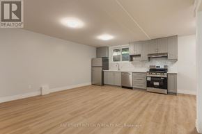Toronto (Palmerston-Little Italy) apartment for rent - A kitchen with a stainless steel refrigerator, oven, and cabinets.