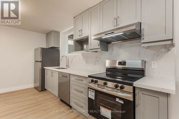 Toronto (Palmerston-Little Italy) apartment for rent - A kitchen with a stove top oven and a refrigerator.