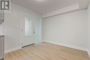 Toronto (Palmerston-Little Italy) apartment for rent - A room with a door and a window with a white wall.