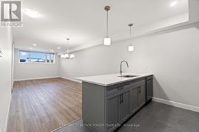The Nation fourplex for rent - A kitchen with a sink and cabinets.